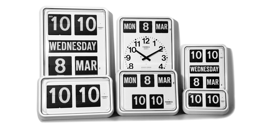 A family of white TWEMCO calendar flip clocks